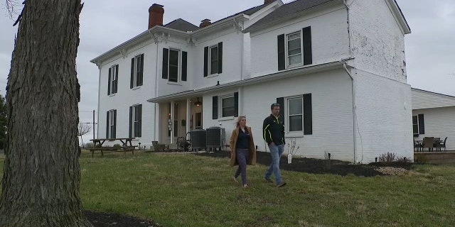 Brad and Dani Cochran outside their farmhouse in Martinsville, Ohio.