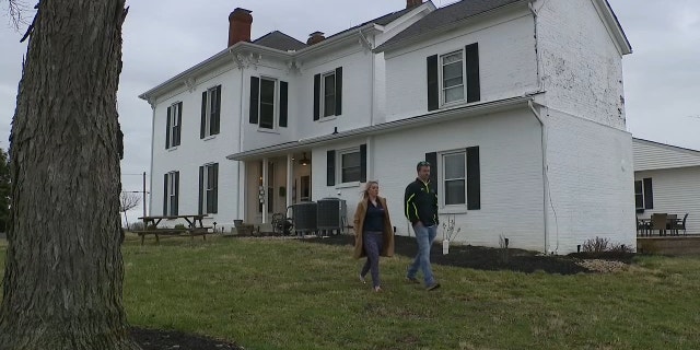 Brad and Dani Cochran outside their farmhouse in Martinsville, Ohio.
