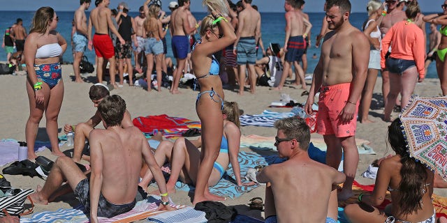 FORT LAUDERDALE, FLORIDA - MARCH 04: People walk on the beach on March 04, 2021 in Fort Lauderdale, Florida. College students have begun to arrive in the South Florida area for the annual spring break ritual. City officials are anticipating a large spring break crowd as the coronavirus pandemic continues. They are advising people to wear masks if they cannot social distance. (Photo by Joe Raedle/Getty Images)