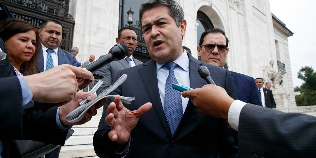 Honduran President Juan Orlando Hernandez speaks to reporters as he leaves a meeting at the Organization of American States, in Washington on Aug. 13, 2019. (AP Photo/Jacquelyn Martin, File)