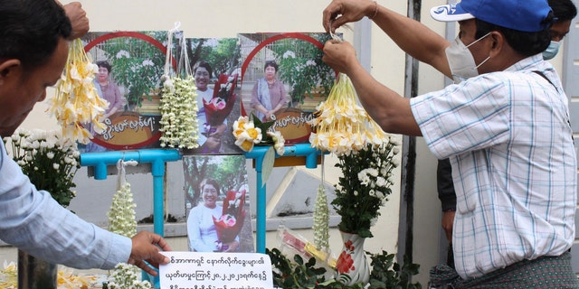 People prepare for a memorial service as a tribute to a teacher who died in a protest on Feb. 28, in Yangon, Burma, Monday, March 1, 2021. (AP Photo)