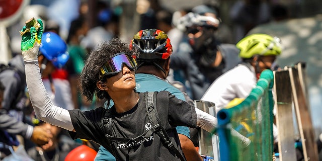 A protester prepares to throw a part of a banana toward the police during a protest against the military coup in Yangon, Burma, Tuesday, March 2, 2021. (AP Photo)