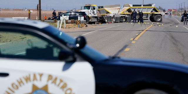 Law enforcement officers work at the scene of a fatal crash in Holtville, California, on Tuesday, March 2, 2021. (AP Photo / Gregory Bull)