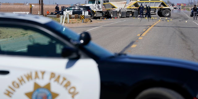 Law enforcement officers work at the scene of a fatal crash in Holtville, Calif. On Tuesday, March 2, 2021 (AP Photo / Gregory Bull)