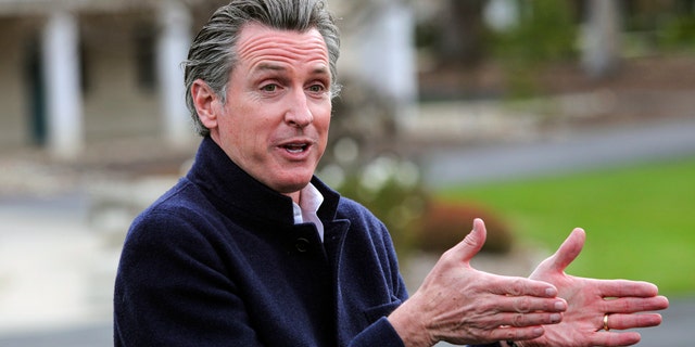 After removing his mask to speak, California Gov. Gavin Newsom delivers comments while visiting one of San Luis Obispo County's vaccination centers at Cuesta College, Tuesday March 2, 2021, in San Luis Obispo, Calif. Newsom was critical of other states that are dropping their masking requirements. (David Middlecamp/The Tribune (of San Luis Obispo) via AP)
