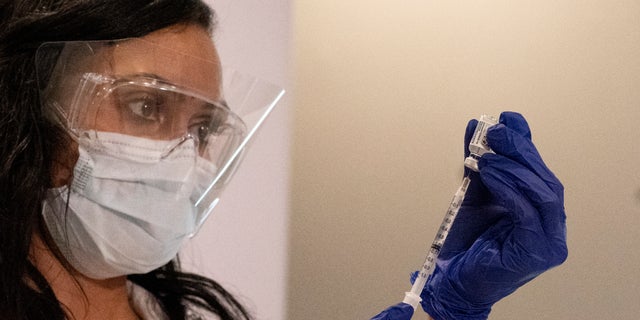 A nurse loads a syringe with the Johnson &amp; Johnson COVID-19 vaccine at a New York hospital (AP Photo/Mark Lennihan)