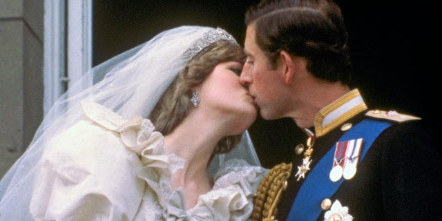 In this July 29, 1981 file photo, Britain's Prince Charles kisses his bride, the former Diana Spencer, on the balcony of Buckingham Palace in London, after their wedding.