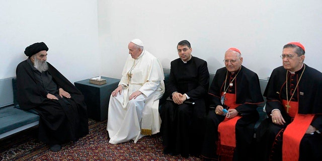 A photo released by the Grand Ayatollah Ali al-Sistani Office shows Shiite Muslim leader, Grand Ayatollah Ali al-Sistani, left, meeting Pope Francis, 2nd left, along with Christian priests in Najaf, Iraq, Saturday, March 6, 2021. Pope Francis arrived in Iraq on Friday to urge the country's dwindling number of Christians to stay put and help rebuild the country after years of war and persecution, brushing aside the coronavirus pandemic and security concerns to make his first-ever papal visit. (AP Photo/HO)