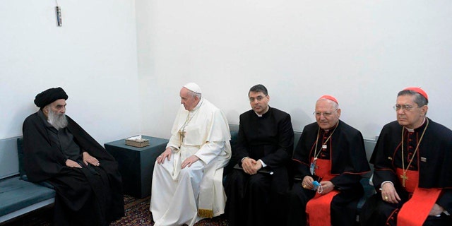 A photo released by the Grand Ayatollah Ali al-Sistani Office shows Shiite Muslim leader, Grand Ayatollah Ali al-Sistani, left, meeting Pope Francis, 2nd left, along with Christian priests in Najaf, Iraq, Saturday, March 6, 2021. Pope Francis arrived in Iraq on Friday to urge the country's dwindling number of Christians to stay put and help rebuild the country after years of war and persecution, brushing aside the coronavirus pandemic and security concerns to make his first-ever papal visit. (AP Photo/HO)