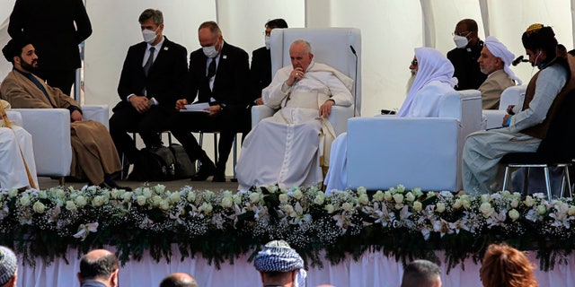 Pope Francis, center, listens during an interreligious meeting near the archaeological site of Ur near Nasiriyah, Iraq, Saturday, March 6, 2021. Pope Francis and Iraq's top Shiite cleric delivered a powerful message of peaceful coexistence Saturday, urging Muslims in the war-weary Arab nation to embrace Iraq’s long-beleaguered Christian minority during an historic meeting in the holy city of Najaf. (AP Photo/Nabil al-Jourani)