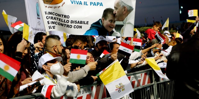 Iraqi Christians say goodbye to Pope Francis after an open air Mass at a stadium in Irbil, Iraq, Sunday, March 7, 2021. Thousands of people filled the sports stadium in the northern city of Irbil for Pope Francis' final event in his visit to Iraq: an open-air Mass featuring a statue of the Virgin Mary that was restored after Islamic militants chopped of the head and hands. (AP Photo/Hadi Mizban)