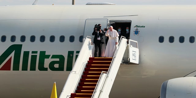 Pope Francis boards a plane upon concluding his visit to Iraq at Baghdad airport, Iraq, Monday, March 8, 2021. (AP Photo/Khalid Mohammed)