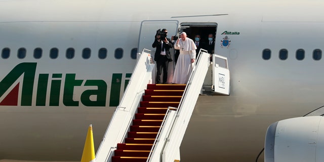 Pope Francis boards a plane upon concluding his visit to Iraq at Baghdad airport, Iraq, Monday, March 8, 2021. (AP Photo/Khalid Mohammed)