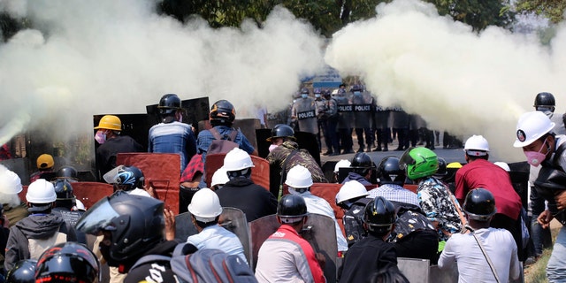 Anti-coup protesters discharge fire extinguishers to counter the impact of the tear gas fired by police during a demonstration in Naypyitaw, Burma, Monday, March 8, 2021. (AP Photo)