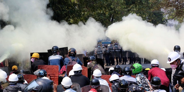Anti-coup protesters discharge fire extinguishers to counter the impact of the tear gas fired by police during a demonstration in Naypyitaw, Burma, Monday, March 8, 2021. (AP Photo)