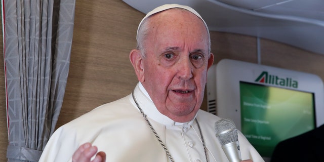 Pope Francis speaks to journalists, Monday, March 8, 2021, while flying back to The Vatican at the end of his four-day trip to Iraq where he met with different Christian communities and Shiite revered cleric Grand Ayatollah Ali al-Sistani. (AP Photo/Yara Nardi, pool)