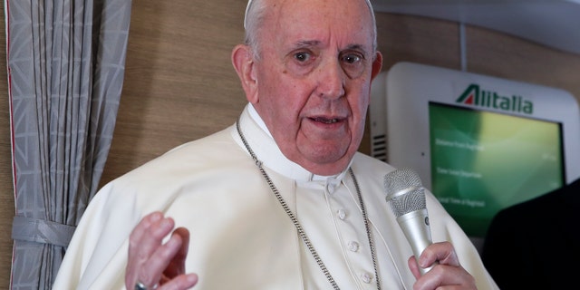 Pope Francis speaks to journalists, Monday, March 8, 2021, while flying back to The Vatican at the end of his four-day trip to Iraq where he met with different Christian communities and Shiite revered cleric Grand Ayatollah Ali al-Sistani. (AP Photo/Yara Nardi, pool)