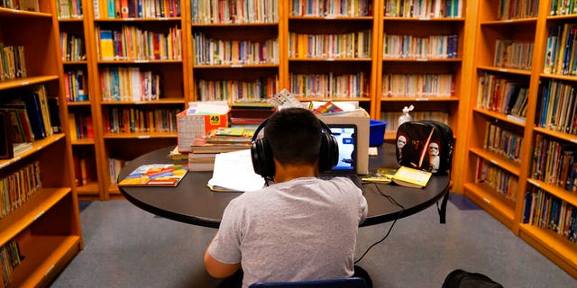 FILE: A Los Angeles Unified School District student attends an online class at the Boys & Girls Club of Hollywood in Los Angeles.