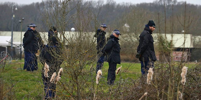 Officers from the Metropolitan Police search land near to Great Chart Golf and Lesiure, in connection with the disappearance of Sarah Everard, in Ashford, England, Wednesday March 10, 2021. Britain's Metropolitan police says an officer has been arrested in connection with the case of a woman who went missing in London last week.  (Gareth Fuller /PA via AP)