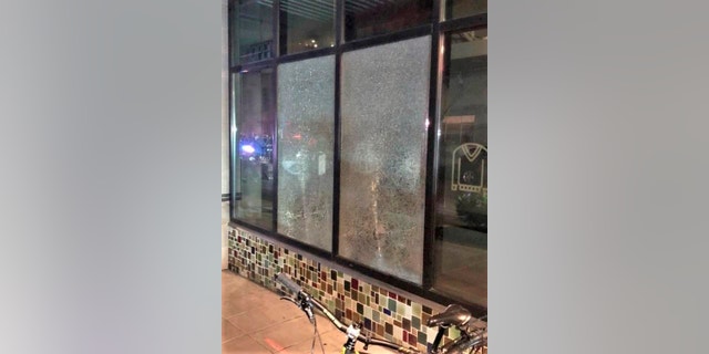 This Friday, March 12, 2021, photo released by Portland Police Bureau shows shmashed windows left behind by people inside the perimeter of a march by a group of about 100 hundred protesters Friday night in Portland, Ore. On Saturday, March 13, 2021, police said officers surrounded the protesters about 15 minutes after the march began in the city's Pearl District at 9 p.m. because some began smashing windows. (Portland Police Department via AP)