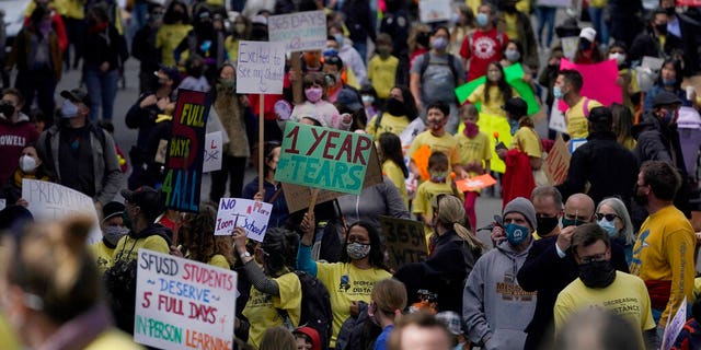 Parents, students, teachers and supporters march during a rally for San Francisco public schools to reopen during the coronavirus pandemic in San Francisco, Saturday, March 13, 2021.