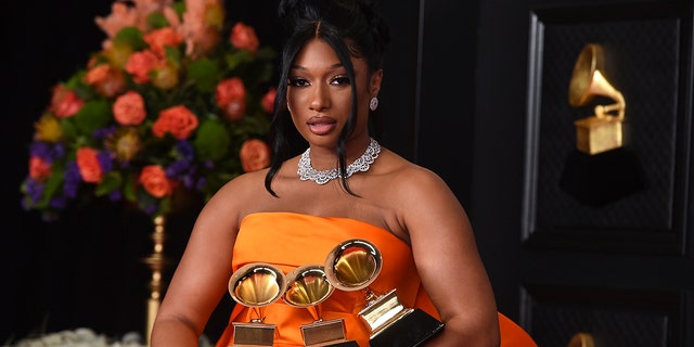 Megan Thee Stallion, winner of the awards for best rap song and best rap performance for "Savage Remix" and best new artist poses in the press room at the 63rd annual Grammy Awards at the Los Angeles Convention Center on Sunday, March 14, 2021. (Photo by Jordan Strauss/Invision/AP)