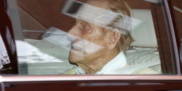 British Prince Philip leaves King Edward VII Hospital in the back of a car in London on Tuesday.  The 99-year-old husband of Queen Elizabeth II has been admitted to hospital after a heart procedure.