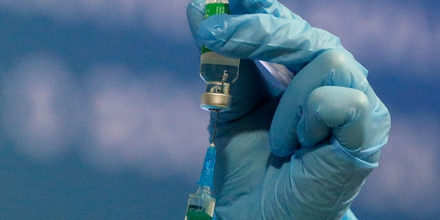 Pharmacist prepares a syringe of the AstraZeneca COVID-19 vaccine marketed under the name CoviShield in Kyiv, Ukraine, Tuesday, March 16, 2021. (AP Photo/Efrem Lukatsky)
