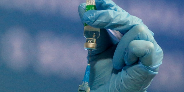 Pharmacist prepares a syringe of the AstraZeneca COVID-19 vaccine marketed under the name CoviShield in Kyiv, Ukraine, Tuesday, March 16, 2021. (AP Photo/Efrem Lukatsky)