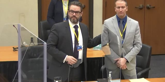 In this screen grab from video, defense attorney Eric Nelson, left, defendant and former Minneapolis police officer Derek Chauvin, right, introduce themselves to jurors as Hennepin County Judge Peter Cahill presides over jury selection in the trial of Chauvin Wednesday, March 17, 2021. (Court TV, via AP, Pool)