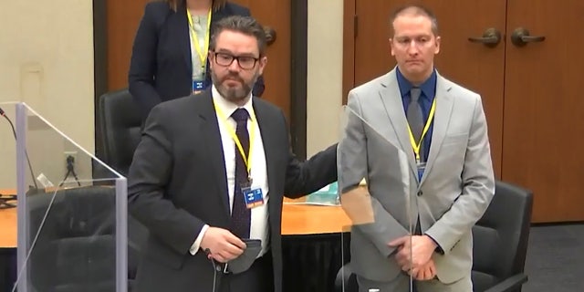 In this screengrab from video, defense attorney Eric Nelson, left, defendant and former Minneapolis police officer Derek Chauvin, right, introduce themselves to jurors as Hennepin County Judge Peter Cahill presides over jury selection in the trial of Chauvin on Wednesday. On Thursday, a 12th juror was seated. (Court TV, via AP, Pool)
