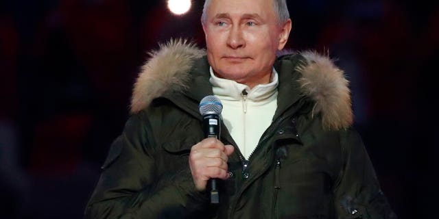 Russian President Vladimir Putin speaks prior to a concert marking the seventh anniversary of the referendum on the state status of Crimea and Sevastopol and its reunification with Russia, in Moscow, Russia, Thursday, March 18, 2021.