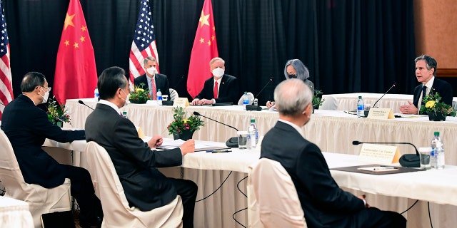 Secretary of State Antony Blinken, far right, speaks as Chinese Communist Party foreign affairs chief Yang Jiechi, left, and China's State Councilor Wang Yi, second from left, listen at the opening session of US-China talks at the Captain Cook Hotel in Anchorage, Alaska, Thursday, March 18, 2021. (Frederic J. Brown/Pool via AP)