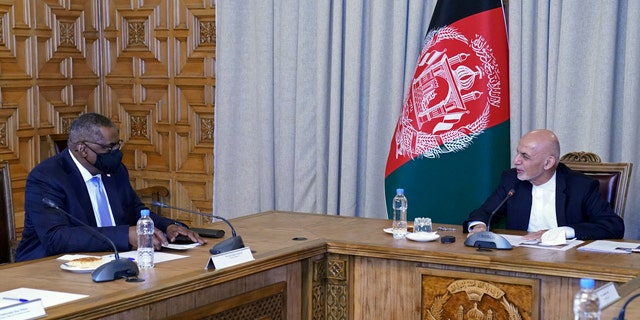 U.S. Defense Secretary Lloyd Austin, left, meets Afgan President Ashraf Ghani at the presidential palace in Kabul, Afghanistan, Sunday, March 21, 2021. Austin arrived in Kabul on his first trip to Afghanistan as Pentagon chief, amid swirling questions about how long American troops will remain in the country. (Presidential Palace via AP)