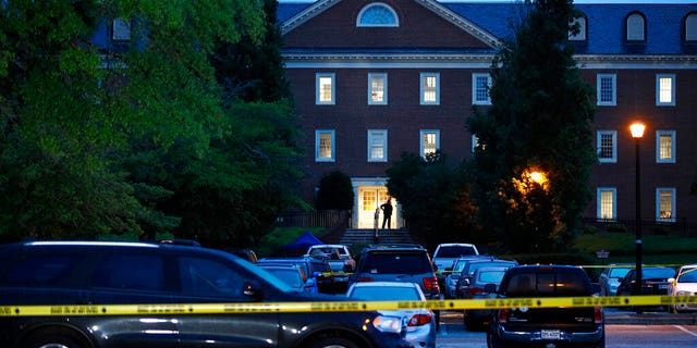 In this Saturday, June 1, 2019 file photo, a law enforcement official stands at an entrance to a municipal building that was the scene of a shooting in Virginia Beach. 