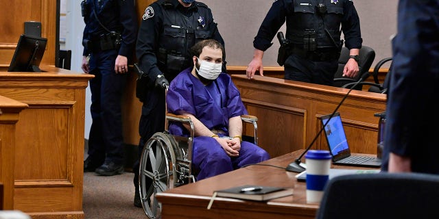 Ahmad Al Aliwi Alissa, 21, appears before Boulder District Court Judge Thomas Mulvahill at the Boulder County Justice Center in Boulder, Colo. on March 25, 2021. Three days after he was led away in handcuffs from a Boulder supermarket where 10 people were fatally shot, Alissa appeared in court for the first time and his defense lawyer asked for a mental health assessment "to address his mental illness."