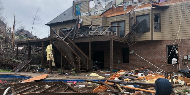 Damage is seen to a home after a tornado passed through the Eagle Point subdivision, Thursday, March 25, 2021, near Birmingham, Ala. (AP Photo/Butch Dill)