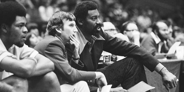 Wilt Chamberlain, right, coach of the San Diego Conquistadors, and assistant coach Stan Albeck, center, watch in the opening minutes of the team's basketball game against the New York Nets in 1974. (Associated Press)