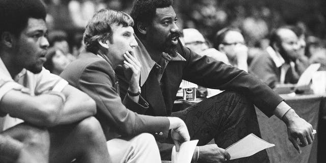 Wilt Chamberlain, right, coach of the San Diego Conquistadors, and assistant coach Stan Albeck, center, watch in the opening minutes of the team's basketball game against the New York Nets in 1974. (Associated Press)