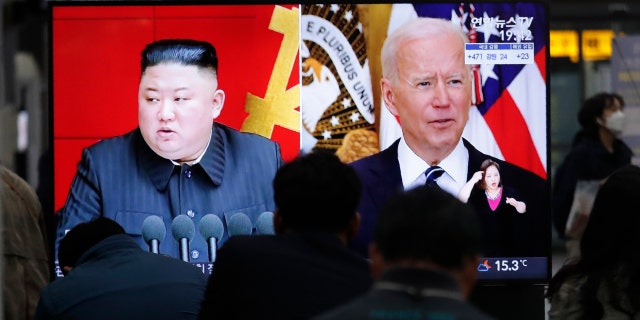 Commuters watch a TV showing a file image of North Korean leader Kim Jong Un and U.S. President Joe Biden during a news program at the Suseo Railway Station in Seoul, South Korea, Friday. March 26, 2021. North Korea on Friday confirmed it had tested a new guided missile, as Biden warned of consequences if Pyongyang escalates tensions amid stalled nuclear negotiations. (AP Photo/Ahn Young-joon)