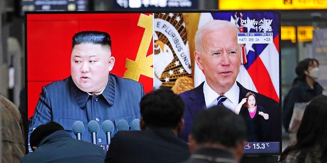 Commuters watch a TV showing a file image of North Korean leader Kim Jong Un and U.S. President Joe Biden during a news program at the Suseo Railway Station in Seoul, South Korea, Friday, March 26, 2021. North Korea on Friday confirmed it had tested a new guided missile as Biden warned of consequences if Pyongyang escalates tensions amid stalled nuclear negotiations. 