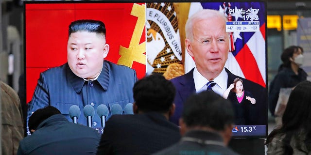 Commuters watch a TV showing a file image of North Korean leader Kim Jong Un and U.S. President Joe Biden during a news program at the Suseo Railway Station in Seoul, South Korea, Friday. March 26, 2021. North Korea on Friday confirmed it had tested a new guided missile, as Biden warned of consequences if Pyongyang escalates tensions amid stalled nuclear negotiations. (AP Photo/Ahn Young-joon)