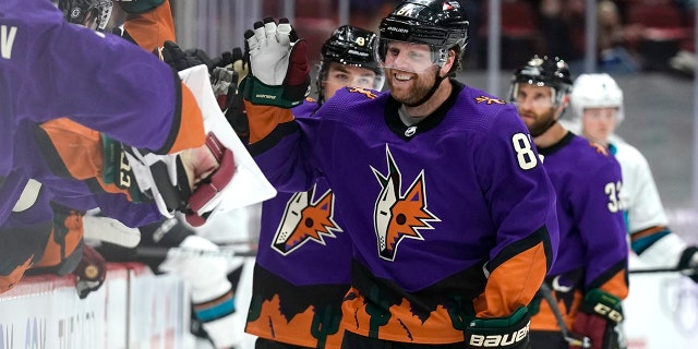 Arizona Coyotes right wing Phil Kessel (81) celebrates with teammates after scoring his third goal of the night against the San Jose Sharks March 27, 2021, in Glendale, Ariz.