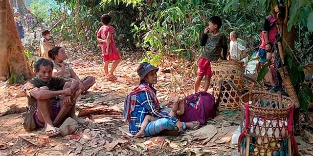 In this photo released by the Free Burma Rangers, Karen villagers gather in the forests as they hide from military airstrikes in the Deh Bu Noh area of the Papun district, north Karen state, Burma, Sunday, March 28, 2021. Thai authorities along its northwestern border braced themselves, Monday, for a possible influx of more ethnic Karen villagers fleeing the fear of renewed air strikes from the Burma military. (Free Burma Rangers via AP)