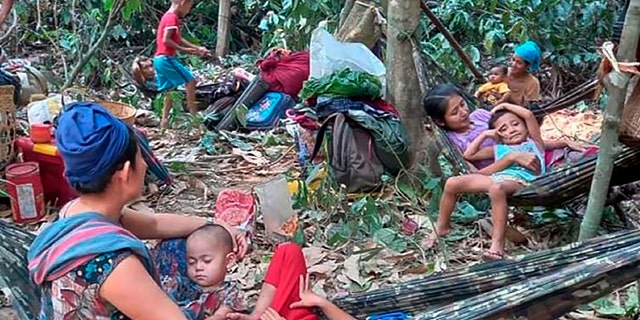 Thousands of people flee airstrikes in Burma, complicating crisis 2 In this photo released by the Free Burma Rangers, Karen villagers gather in the forests as they hide from military airstrikes in the Deh Bu Noh area of Papun district in northern Karen state, in Burma, Sunday March 28, 2021 (Credit: Free Burma Rangers via AP)