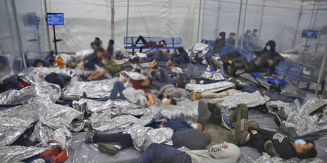Young children rest inside a pod at the U.S. Customs and Border Protection facility, the main detention center for unaccompanied children in the Rio Grande Valley, in Donna, Texas. (AP Photo/Dario Lopez-Mills, Pool)