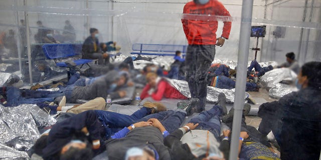 Young children lie inside a pod at the Donna Department of Homeland Security holding facility, the main detention center for unaccompanied children in the Rio Grande Valley run by U.S. Customs and Border Protection, in Donna, Texas, Tuesday, March 30, 2021.(AP Photo/Dario Lopez-Mills, Pool)