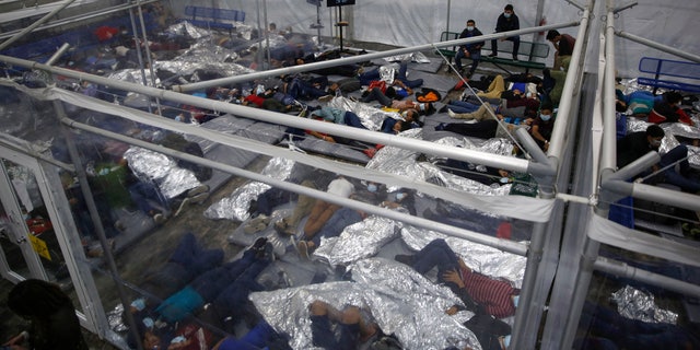 Minor children rest in a pod at the Donna Department of Homeland Security detention center, the primary detention center for unaccompanied children in the Rio Grande Valley operated by the United States Customs and Border Protection (CBP) , in Donna, Texas, Tuesday, March 30, 2021 The miners are housed by the hundreds in eight pods of approximately 3,200 square feet.  Most of the pods contained more than 500 children.  The Biden administration on Tuesday for the first time allowed reporters into its main border detention center for migrant children, revealing a severely overcrowded tent structure where more than 4,000 children and families were crammed into pods and younger children kept in a large play area with mats on the ground to sleep on.  (AP Photo / Dario Lopez-Mills, Pool)