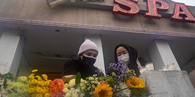 Mourners visit and leave flowers at the site of two shootings at spas across the street from one another, in memorial for the lives lost, on March 17, 2021 in Atlanta, Georgia. (Megan Varner/Getty Images)