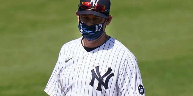 New York Yankees' Manager Aaron Boone stands on the field before a spring baseball game against the Toronto Blue Jays Sunday, Feb. 28, 2021, in Tampa, Fla. (AP Photo/Frank Franklin II)